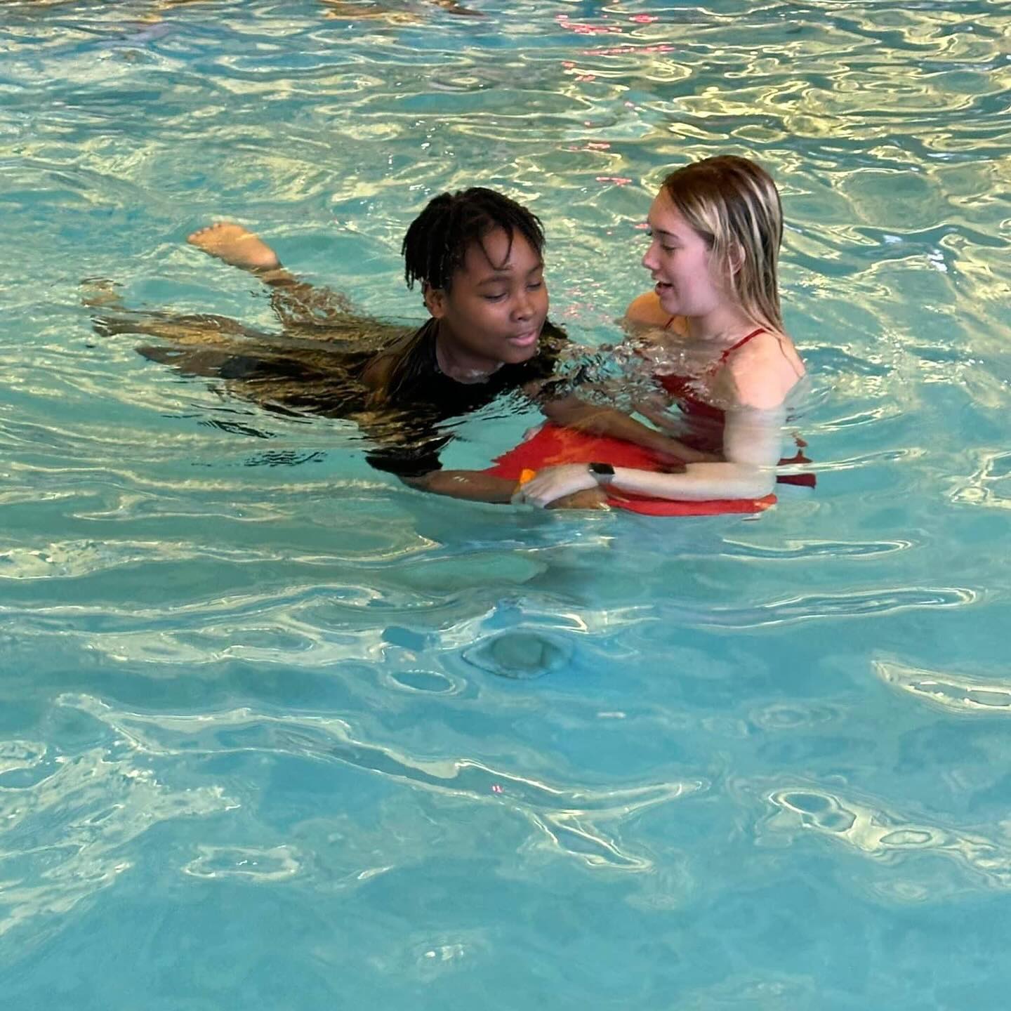 a young student taking swim lessons